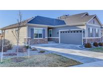 Charming single-story home featuring stone accents and a spacious driveway leading to the attached garage at 12668 Ulster St, Thornton, CO 80602