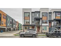 Modern townhome featuring a blend of stone, siding, and wood accents, showcasing contemporary architectural design at 2545 Josephine Way, Superior, CO 80027
