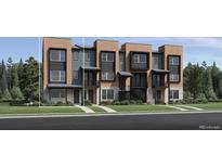Modern townhome exterior with multi-tone facade, black trim, a covered entry, and professional landscaping at 2545 Josephine Way, Superior, CO 80027