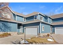 Charming townhome with blue siding, stone accents, and attached two-car garage at 281 Rockview Dr, Superior, CO 80027
