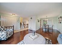 Inviting living room with hardwood floors and staircase to the upper level at 8364 Allison Ct, Arvada, CO 80005