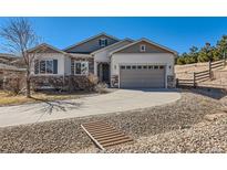 Charming two-story home featuring a well-manicured yard and a spacious two-car garage with a curved driveway at 3309 Thornwood Ct, Castle Rock, CO 80108