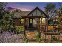 Charming brick home featuring a welcoming front garden and inviting architectural details at 4419 Julian St, Denver, CO 80211