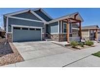 Charming home with a well-manicured lawn, attached garage, and beautiful stone accents at 11494 Colony Loop, Parker, CO 80138