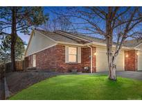 Charming red brick home with well-maintained lawn and attached two car garage at 12370 Saint Paul Ct, Thornton, CO 80241
