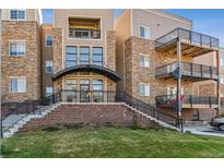 Attractive multi-story condo building features stone accents and private balconies at 6000 W Floyd Ave # 116, Denver, CO 80227