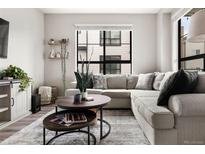 Bright living room featuring a comfortable sectional sofa and modern decor at 1990 S Holly St # 3, Denver, CO 80222