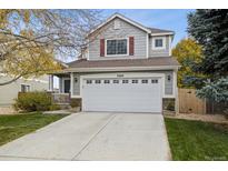 Two-story house with attached garage and landscaped front yard at 5604 S Yakima Way, Aurora, CO 80015