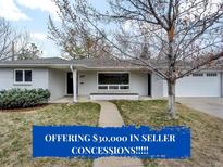 Charming single-story home with a well-maintained lawn and an inviting walkway to the front door at 2455 E Yale Ave, Denver, CO 80210