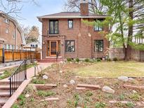 Charming brick home with a well-maintained front yard and inviting curb appeal at 1944 Hudson St, Denver, CO 80220