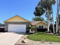 Charming one-story home with a well-manicured lawn, a two car garage and tasteful exterior at 1030 S Fulton Ave, Fort Lupton, CO 80621