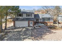 Charming two-story home with a brick and siding facade, showcasing a well-maintained front yard and attached garage at 11231 Clermont Dr, Thornton, CO 80233