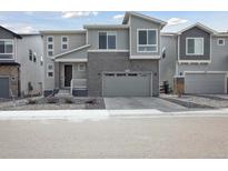 Charming two-story home with brick accents and a well-manicured front yard at 741 Simmental Loop, Castle Rock, CO 80104