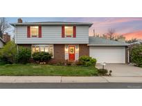 Charming two-story home featuring brick and siding, plus red accents on the front door and shutters at 6984 E Montana Pl, Denver, CO 80224