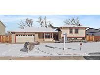 Charming single-Gathering home featuring a two-car garage and manicured lawn, perfect for suburban living at 9803 E Exposition Ave, Denver, CO 80247