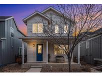 Two-story house with blue door and porch at 4715 Crestone Peak St, Brighton, CO 80601