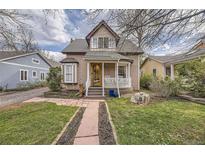 Charming home featuring a cozy front porch, landscaped yard and eye-catching stonework walkway at 826 Maxwell Ave, Boulder, CO 80304