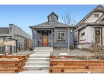 Charming home with a blue exterior, concrete steps and curated landscaping at 3242 N Williams St, Denver, CO 80205