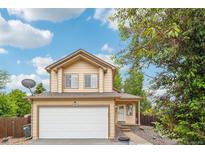 Charming two-story home with a well-maintained lawn, attached garage and beautiful front entrance at 5262 E Sandpiper Ave, Castle Rock, CO 80104