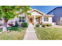 Charming single-story home featuring a welcoming front porch, manicured lawn, and lovely landscaping at 14230 Lakeview Ln, Broomfield, CO 80023
