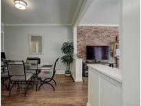 Bright dining area with glass table and four chairs, adjacent to living room at 521 E 14Th Ave # 18, Denver, CO 80203