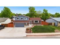 Charming two-story home with a well-maintained front yard and a two car garage, perfect for suburban living at 7350 Devinney Ct, Arvada, CO 80005
