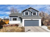 Charming two-story home with a well-maintained lawn and a two-car garage at 13399 Wyandot St, Denver, CO 80234