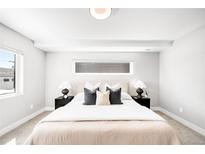 Bright bedroom featuring a queen bed, black nightstands, and a light color palette at 3658 Quivas St, Denver, CO 80211