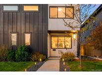 Charming modern home with a well-lit walkway, manicured lawn, and stylish architectural details at 3658 Quivas St, Denver, CO 80211