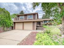 Charming two-story home featuring an attached two car garage and well-maintained landscaping at 2621 S Kingston Ct, Aurora, CO 80014