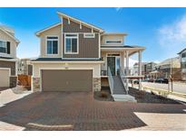 Inviting two-story home with a two-car garage and a charming front porch in a desirable neighborhood at 10136 Yampa Ct, Commerce City, CO 80022