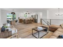 Open floor plan showing the living room, kitchen, and dining area at 10863 W 67Th Pl, Arvada, CO 80004
