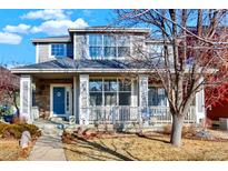 Charming two-story home featuring a welcoming front porch with stone accents and well-maintained landscaping at 16367 E Auburn Hills Dr, Parker, CO 80134