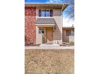 Charming townhome features a brick facade and covered entrance, creating a welcoming curb appeal at 2279 Coronado Pkwy # B, Denver, CO 80229