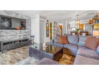 Inviting living room featuring a stone accent wall and comfortable seating area at 2279 Coronado Pkwy # B, Denver, CO 80229