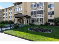 Exterior shot of a building with a beautiful green lawn and flower bed at 695 S Alton Way # 5A, Denver, CO 80247