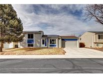 Charming two-story home showcasing solar panels, blue accents, and a well-manicured lawn at 4319 E 118Th Ave, Thornton, CO 80233