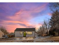 Updated Ranch home exterior boasts a bright green door and landscaped yard at 1846 S Lowell Blvd, Denver, CO 80219