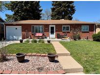 Charming brick ranch-style home featuring a well-manicured front yard and inviting front porch at 2213 S Meade Street, Denver, CO 80219