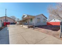 Cozy single-story home with a covered front porch and spacious concrete driveway at 4024 W Kentucky Ave # A And B, Denver, CO 80219