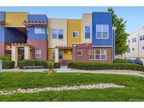 Colorful condo with brick accents, beautiful landscaping, and a well-maintained lawn at 11316 Colony Cir, Broomfield, CO 80021