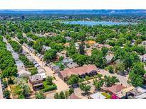 Stunning aerial view showcasing a neighborhood with mature trees and a large lake in the background at 3922 W 29Th Ave, Denver, CO 80212