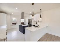 Modern kitchen features a large island, stainless steel appliances, and stylish pendant lighting at 3922 W 29Th Ave, Denver, CO 80212