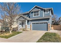 Charming two-story home with a two car garage and blue siding, complemented by stone accents at 2649 Westgate Ave, Highlands Ranch, CO 80126