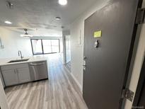 Modern kitchen with stainless steel appliances and wood-look floors at 100 Park Ave # 1405, Denver, CO 80205