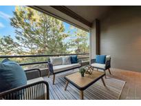 Outdoor seating area on balcony featuring modern furniture with a view of trees at 867 Hill And Dale Rd # B, Golden, CO 80401