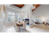 Bright dining room with modern furnishings, fireplace, and floor-to-ceiling windows at 867 Hill And Dale Rd # B, Golden, CO 80401