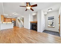 Bright living room with hardwood floors, fireplace, and kitchen access at 250 Laramie Blvd, Boulder, CO 80304