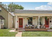 Charming duplex featuring inviting front porches with colorful decor and blooming flower baskets at 4165 Winona Ct, Denver, CO 80212