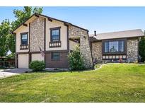 Charming two-story home with stone accents and a well-manicured front yard at 5197 S Perry St, Littleton, CO 80123